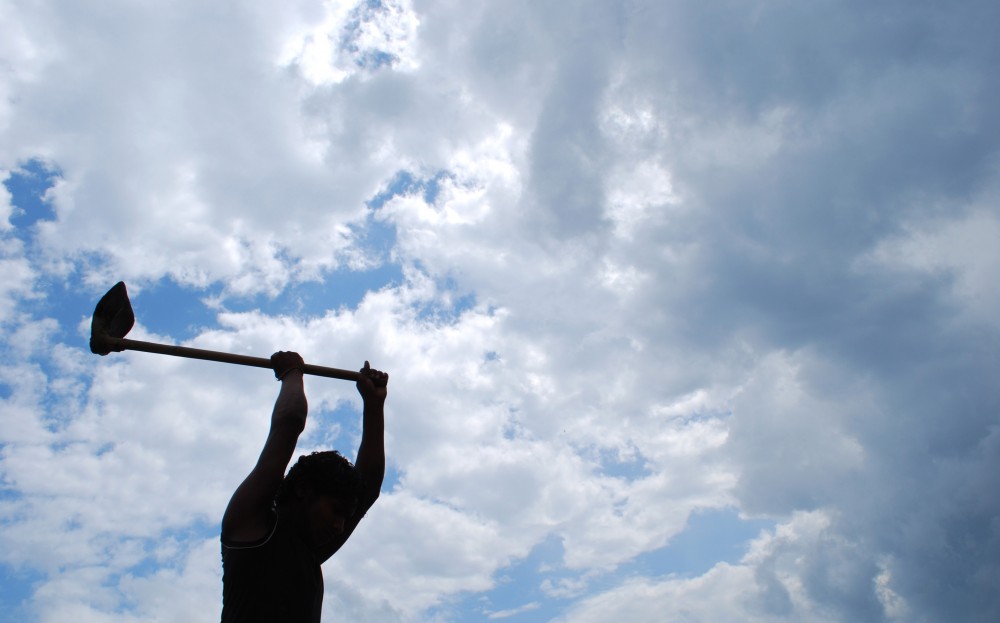 File Photo: A farmer is silhouetted against monsoon clouds as he ploughs his field in Dimapur. (Morung File Photo by Caisii Mao)